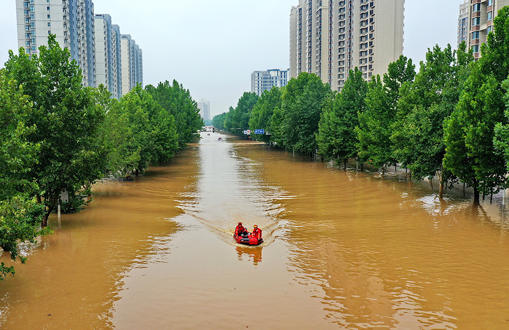 救援人員在河北省涿州市市區(qū)乘坐沖鋒舟前去轉移受災群眾（8月2日攝，無人機照片）。